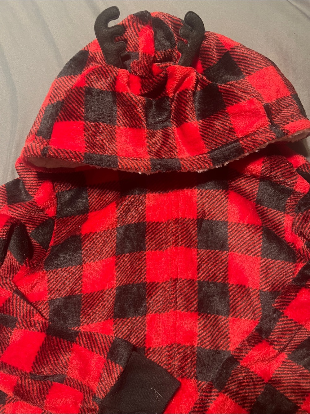 Unisex red and black plaid onesie with reindeer ears on hood. Adult medium